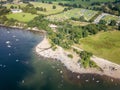 Crowds of people on a small lakeside beach in the middle of summer (Ullswater, Lake District, England