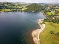 Crowds of people on a small lakeside beach in the middle of summer (Ullswater, Lake District, England