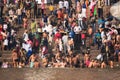 Crowds of people the stairs of the embankment of the river Ganges, Varanasi, India.