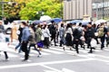 crowds of people crossing a street in Tokyo, Japan, while it is raining Royalty Free Stock Photo