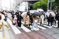 crowds of people crossing a street in Tokyo, Japan, while it is raining Royalty Free Stock Photo