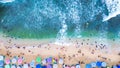 crowds of people vacationing on the beautiful and cool beach