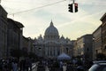 Crowds of people walk near the St Peter`s Basilica at the sunset in Rome, Italy. St Peter`s