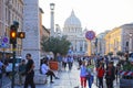 Crowds of people walk near the St Peter`s Basilica at the sunset in Rome, Italy. St Peter`s cathedral in Vatican City is one of Royalty Free Stock Photo