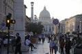 Crowds of people walk near the St Peter`s Basilica at the sunset in Rome, Italy. St Peter`s