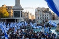 Crowds of people waving Israeli flags at pro-Israel solidarity rally at Trafalgar Square in London, UK