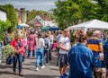 Crowds shopping at street stalls during Nunney Fayre in Nunney, Somerset,