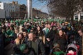 Crowds in the street in Irish top hats and green clothes in Dublin, Ireland on St. Patrick`s Day