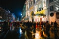 Crowds strolling down a rain-soaked street at night near Piccadilly Circus, London, UK Royalty Free Stock Photo