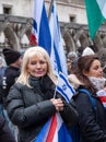 Woman holding signs and flags at the March Against Antisemitism, in central London UK during the Israel Gaza conflict.