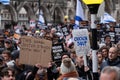 People holding banners and flags at the March Against Antisemitism, in central London UK during the Israel Gaza conflict.