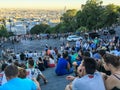 Crowds of tourists sit on Sacre Coeur stairs and view skyline of Paris from Montmartre Royalty Free Stock Photo