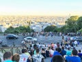 Crowds of tourists sit on Sacre Coeur stairs and view skyline of Paris from Montmartre Royalty Free Stock Photo