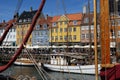 Crowds of tourists walk along the colorful row houses in idyllic Copenhagen. Royalty Free Stock Photo