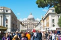 Crowds of tourists walk around the Cathedral of St. Peter in Rom