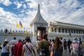 Crowds of tourists walk toward the entrace to the Royal Grand Palace, a famous tourist