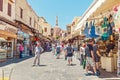 Crowds of tourists walking and shopping at market street in Rhodos town, leading to famous Mosque