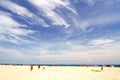 Crowed people on white sand beach and blue sky