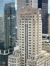 Croweds of people gather on a rooftop deck and a mid-building deck