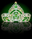 crown, diadem, shiny tiara with emeralds on a dark background with reflection