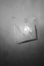 Crown isolated on gray misted glass background. Emperor treasure. Close up covid symbol