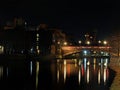 Crown point bridge crossing the river aire in leeds at night with lights and surrounding buildings reflected in the water Royalty Free Stock Photo