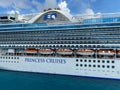 The Crown Princess cruise ship, is owned by Carnival Corporation, docked at Aruba on a sunny day with blue skies