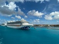 The Crown Princess cruise ship, is owned by Carnival Corporation, docked at Aruba on a sunny day with blue skies