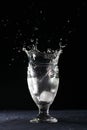 Crown splash in a glass of clear cold water tempting for a drink. Isolated on black Royalty Free Stock Photo