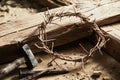 Crown of thorns among cross, hammer with nails