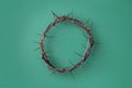 Crown of thorns on green background. Top view. Copy space. Christian Easter concept. Crucifixion of Jesus Christ. He Royalty Free Stock Photo