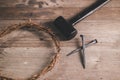 Crown of thorns with iron nails and a hammer on rustic wooden table, dramatic light and copy space, symbolizing crucifixion, Royalty Free Stock Photo