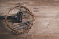 Crown of thorns with iron nails and a hammer on rustic wooden table, dramatic light and copy space, symbolizing crucifixion, Royalty Free Stock Photo