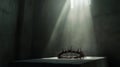A crown of thorns rests on a simple cloth-draped table in a dimly lit room Royalty Free Stock Photo