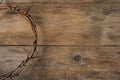 Crown of thorns on wooden background, top view with space for text. Easter attribute Royalty Free Stock Photo