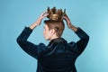 Crown yourself, a successful young businessman with a crown over head.