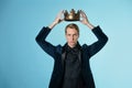Crown yourself, a successful young businessman with a crown over head.