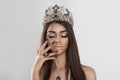 Crowned dark beauty queen. Closeup portrait brunette woman fashion model girl beautiful shiny makeup eye shadow lipstick jewelry