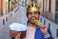 Crowned young guy with full wallet Royalty Free Stock Photo