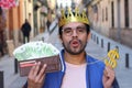 Crowned young guy with full wallet Royalty Free Stock Photo