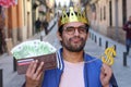 Crowned young guy with full wallet Royalty Free Stock Photo