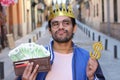 Crowned young guy with full wallet Royalty Free Stock Photo