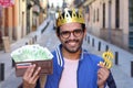 Crowned young guy with full wallet Royalty Free Stock Photo