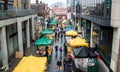 Croydon Surrey street market on a rainy day with sellers selling fruits and vegetables