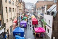 Croydon Surrey street market on a rainy day with sellers selling fruits and vegetables