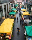 Croydon Surrey street market on a rainy day with sellers selling fruits and vegetables