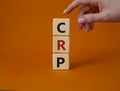 CRP - C-Reactive Protein Test symbol. Wooden cubes with word CRP. Doctor hand. Beautiful orange background. Medical and C-Reactive Royalty Free Stock Photo