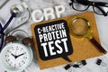 CRP - C-Reactive Protein Test text with Stethoscope, alarm clock and magnifying glass on marble background Royalty Free Stock Photo