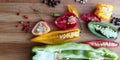 Many different kinds of pepper in wooden background