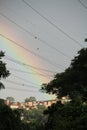 Rainbow over houses and cables energy trees Royalty Free Stock Photo
